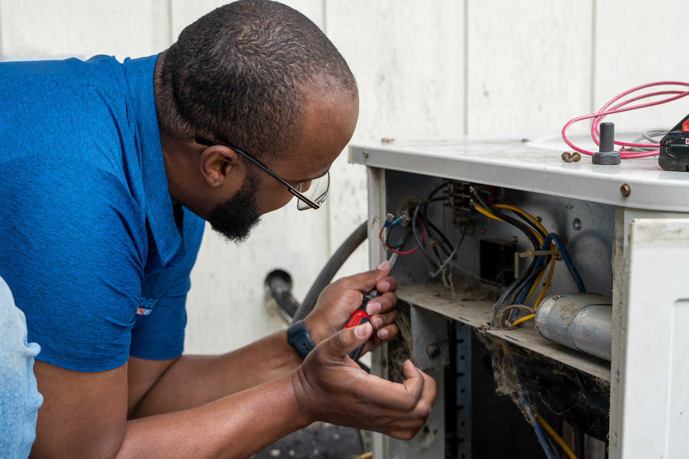 R3 technician performing HVAC repair in Davenport, Iowa